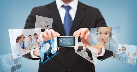 business, internet and technology concept - businessman showing smartphone with news on screenの写真素材