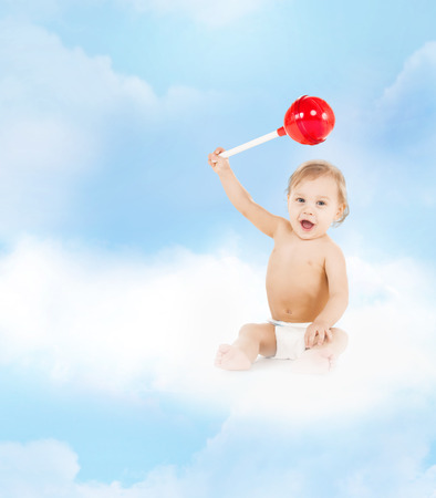 childhood and toys concept - cute little boy playing with big lollipopの写真素材