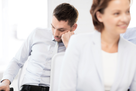 business concept - tired businessmen sleeping on conference or meetingの写真素材