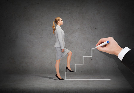 business and education concept - businesswoman stepping up staricaseの写真素材