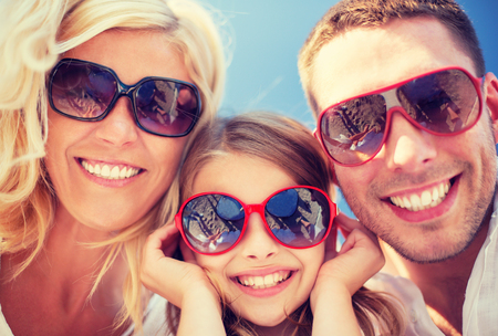 summer holidays, children and people concept - happy family with blue skyの写真素材