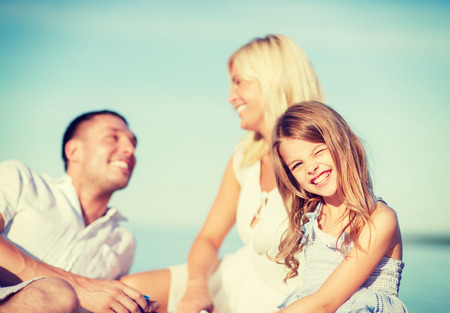 summer holidays, children and people concept - happy family having a picnicの写真素材