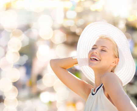 fashion, happiness and lifestyle concept - beautiful woman in hat enjoying summer outdoorsの写真素材