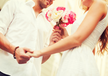 summer holidays, love, relationship and dating concept - couple with bouquet of flowers in the city summer holidays, love, relationship and dating concept - couple with bouquet of flowers in the city