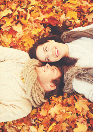 holidays, love, relationship and dating concept - romantic couple in the autumn parkの写真素材