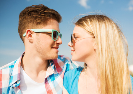 holidays, vacation, love and friendship concept - smiling couple having fun outdoorsの写真素材