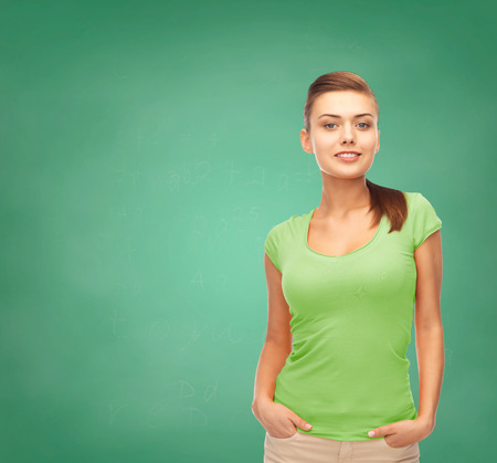 education, t-shirt design and people concept - smiling young woman in blank green t-shirtの写真素材