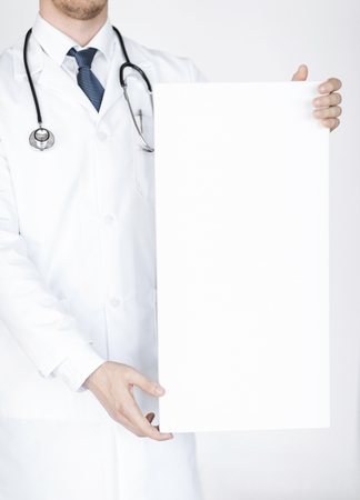close up of doctor holding blank white bannerの写真素材
