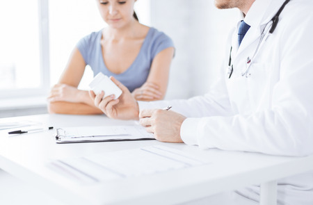 close up of patient and doctor prescribing medicationの写真素材