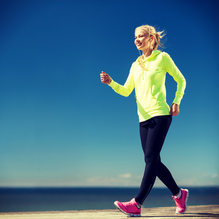 fitness and lifestyle concept - woman walking outdoors fitness and lifestyle concept - woman walking outdoors