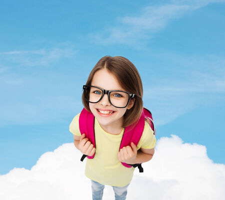 education and school concept - happy and smiling teenage girl in eyeglasses with bagの写真素材
