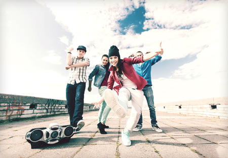 sport, dancing and urban culture concept - group of teenagers dancingの写真素材