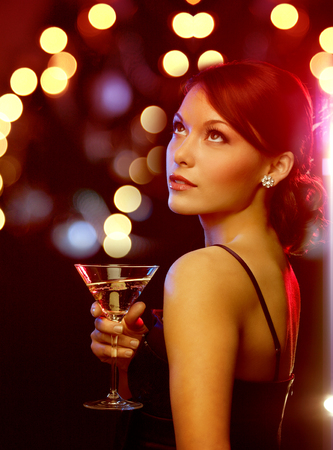 luxury, vip, nightlife, party concept - beautiful woman in evening dress with cocktailの写真素材