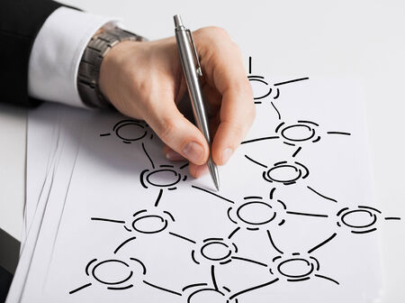 business, marketing, planning and people concept - close up of male hand with pen drawing graph on...