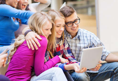 education, high school, technology and people concept - group of smiling students with tablet pc computers taking photo or video indoorsの写真素材