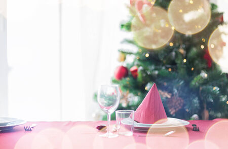 holidays, celebration and home concept - close up of room with christmas tree and decorated table