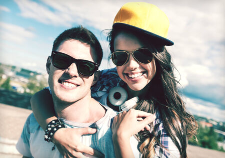 summer holidays and teenage concept - teenagers having fun outsideの写真素材