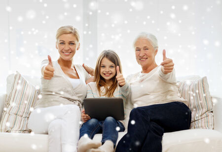family, generation, technology and people concept - smiling mother, daughter and grandmother with...