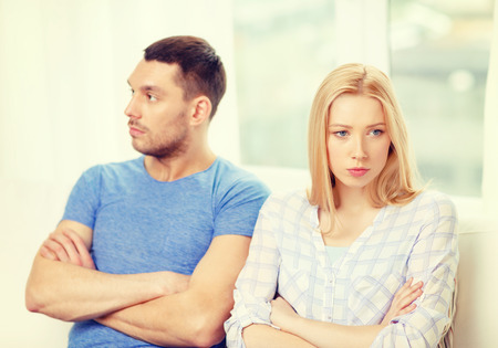 love, family and relationship problems concept - unhappy couple not speaking after having argument at homeの写真素材