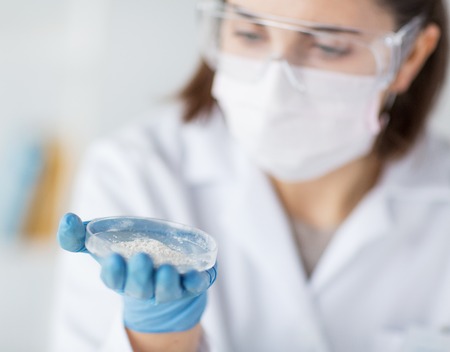 science, chemistry, biology, medicine and people concept - close up of young female scientist...