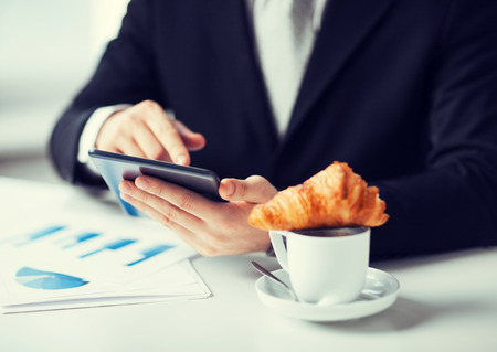 close up of man with tablet pc and cup of coffeeの写真素材