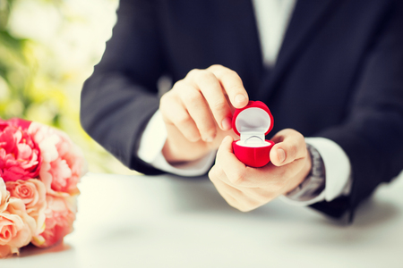 picture of man with gift box and wedding ringの写真素材