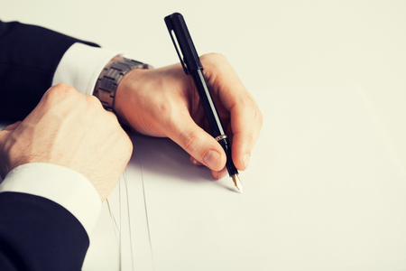 picture of businessman writing something on the paperの写真素材