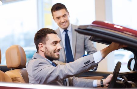 auto business, car sale, consumerism and people concept - happy man with car dealer in auto show or...