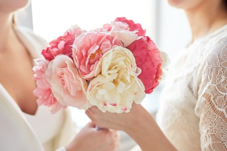 close up of happy married couple with flower bunch