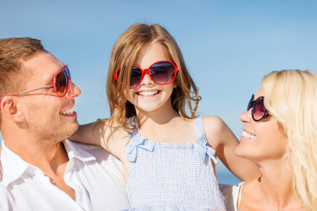 summer holidays, children and people concept - happy family with blue skyの写真素材