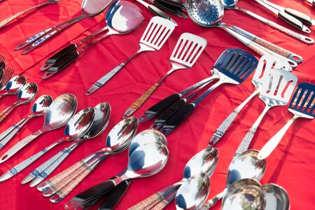 tableware and kitchenware concept - spoons and spatulas sale at street marketの写真素材
