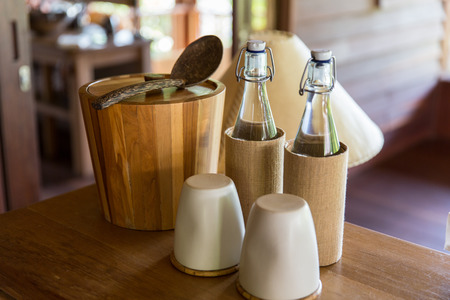 tableware and kitchenware concept - couple of bottles and glasses on table at hotel roomの写真素材