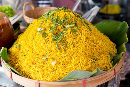 cooking, asian kitchen, sale and food concept - cooked noodles at street marketの写真素材