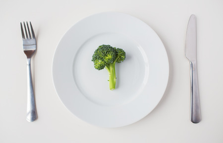 healthy eating, diet, vegetarian food and culinary concept - close up of broccoli on plateの写真素材