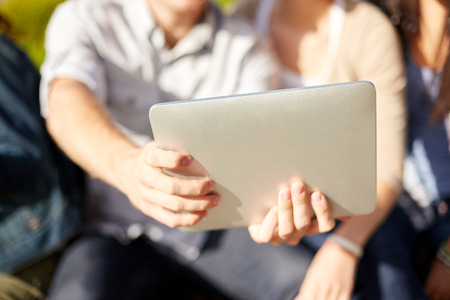 summer, technology and people concept - close up of friends with tablet pc taking selfieの写真素材
