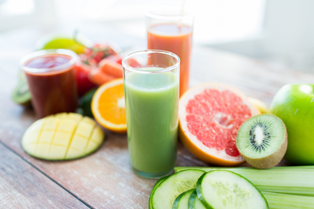 healthy eating, food and diet concept- close up of fresh juice glass and fruits on table