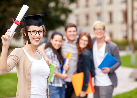 group of happy teenage students with diploma school foldersの写真素材