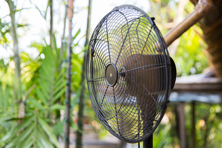 cooling, freshness and heat concept - close up of fan outdoorsの写真素材