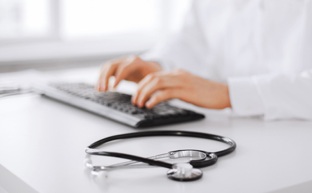 male doctor typing on the keyboardの写真素材