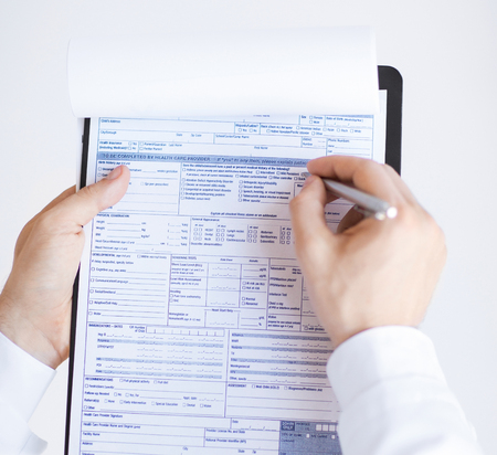 close up of male doctor holding prescription paper in handの写真素材