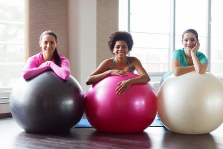 fitness, sport, training and lifestyle concept - group of smiling women with exercise balls in gymの写真素材