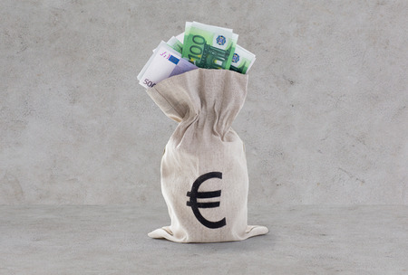 business, finance, investment, saving and cash concept - close up of euro paper money in bank bag...