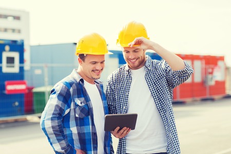 business, building, teamwork, technology and people concept - group of smiling builders in hardhats...