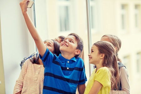 education, elementary school, drinks, children and people concept - group of school kids taking...