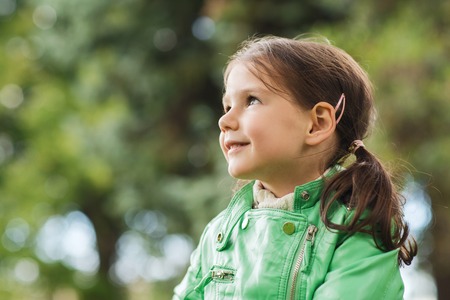 summer, childhood, happiness and people concept - happy beautiful little girl portrait outdoorsの写真素材