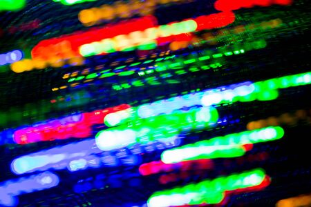 holidays, illumination and electricity concept - colorful bright night lights stream over black backgroundの写真素材