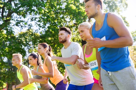 fitness, sport, race and healthy lifestyle concept - group of teenage friends or sportsmen with...