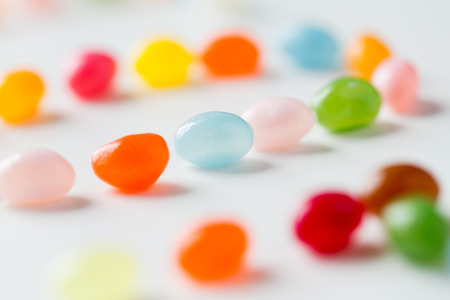 food, sweets, confectionery and unhealthy eating concept - close up of colorful jelly beans candies on tableの写真素材