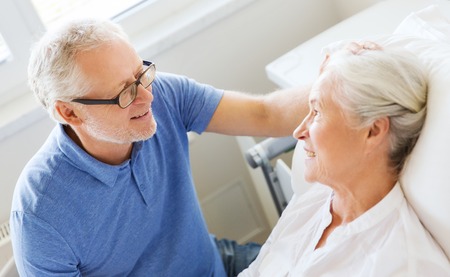 medicine, age, support, health care and people concept - happy senior man visiting and cheering his...