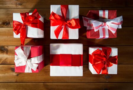 christmas, holidays, presents, new year and celebration concept - close up of gift boxes and red...